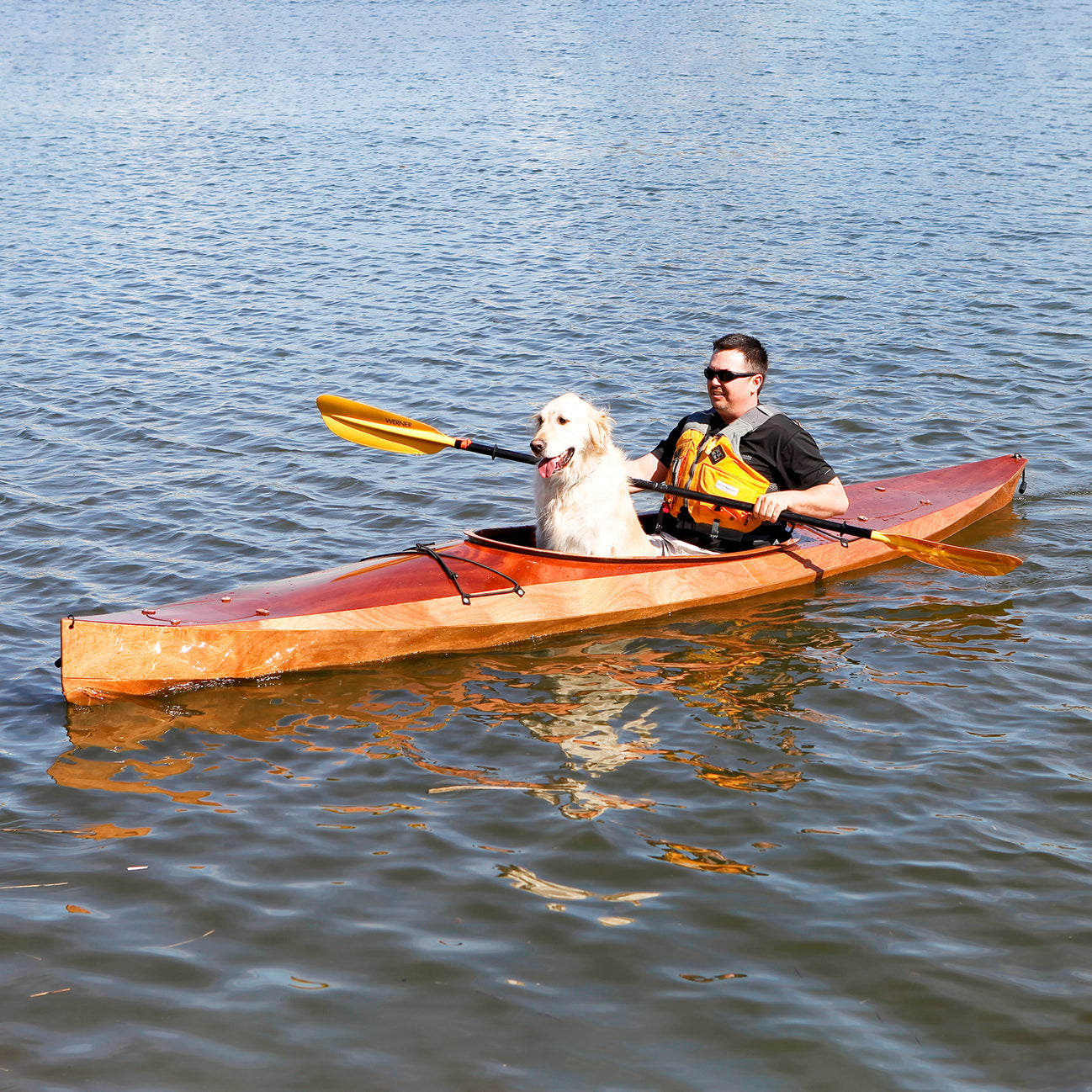 A man and his best friend paddling a Wood Duck 14 kayak