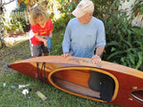 A young builder with his Wood Duckling kayak, guided by Grandpa