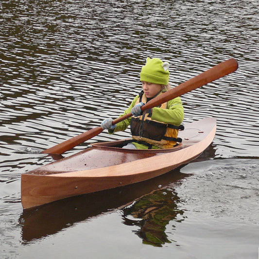 A kid out for a paddle in a Wood Duckling 8 kayak